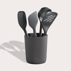 The Zyliss 5-Piece Utensil Set includes dark gray spatulas and serving spoons in a matching holder. All tools are dishwasher safe, making this set perfect for any modern kitchen.
