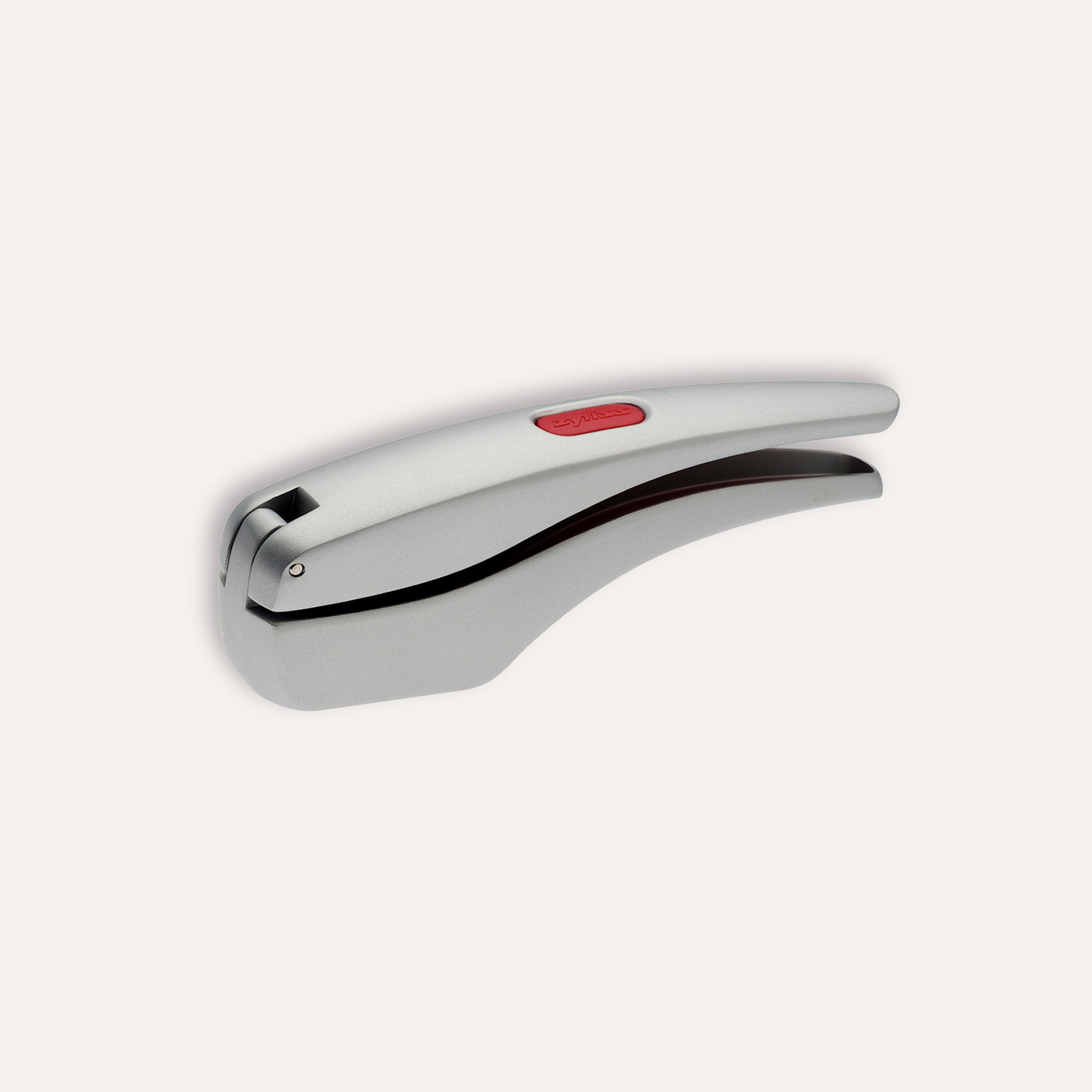 The Zyliss Susi 3 Garlic Press, made of stainless steel with an ergonomic handle and red accent, is shown closed on a white background. Itβs dishwasher safe for easy cleaning.