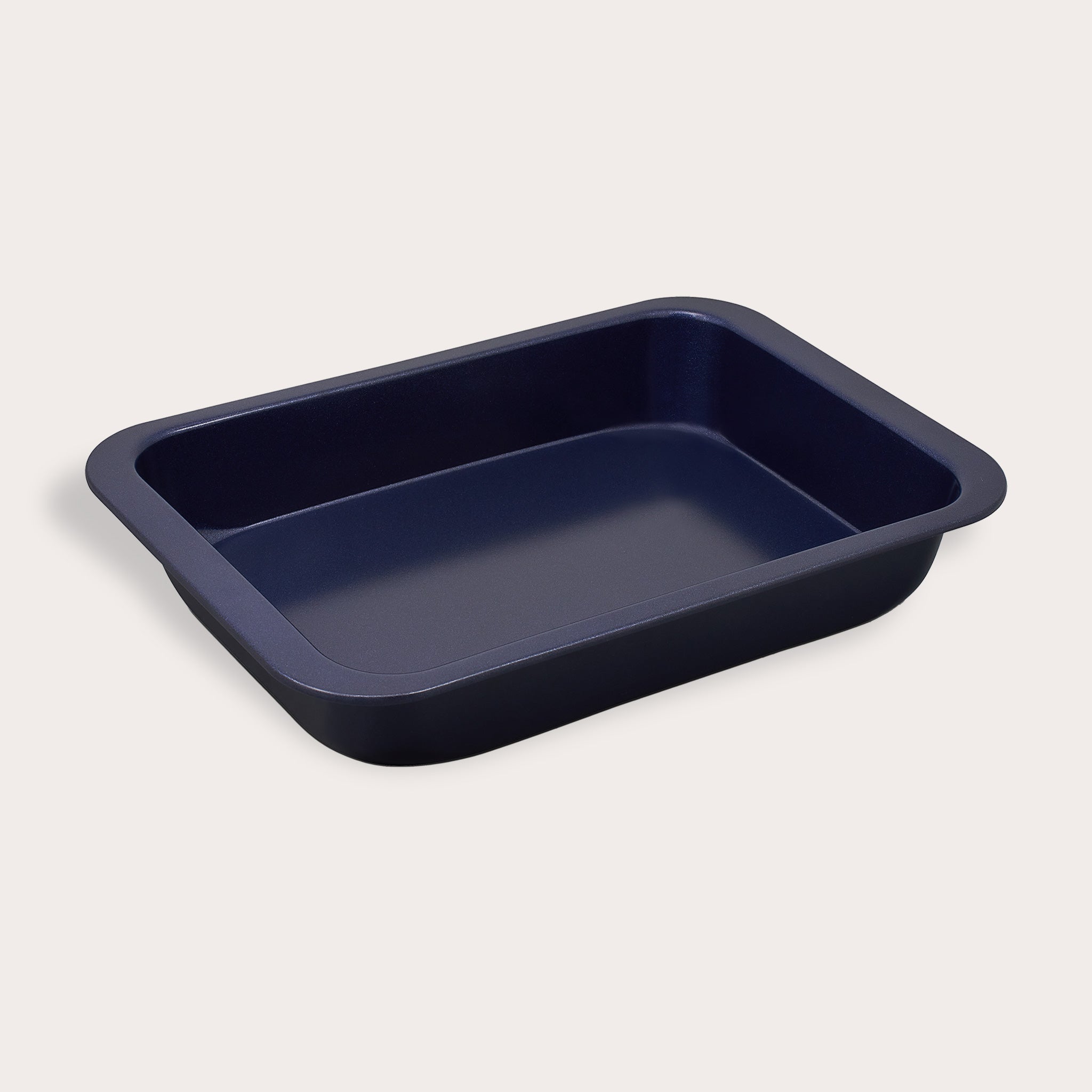A black rectangular baking pan with rounded corners and slightly flared sides, shown on a plain light background.
