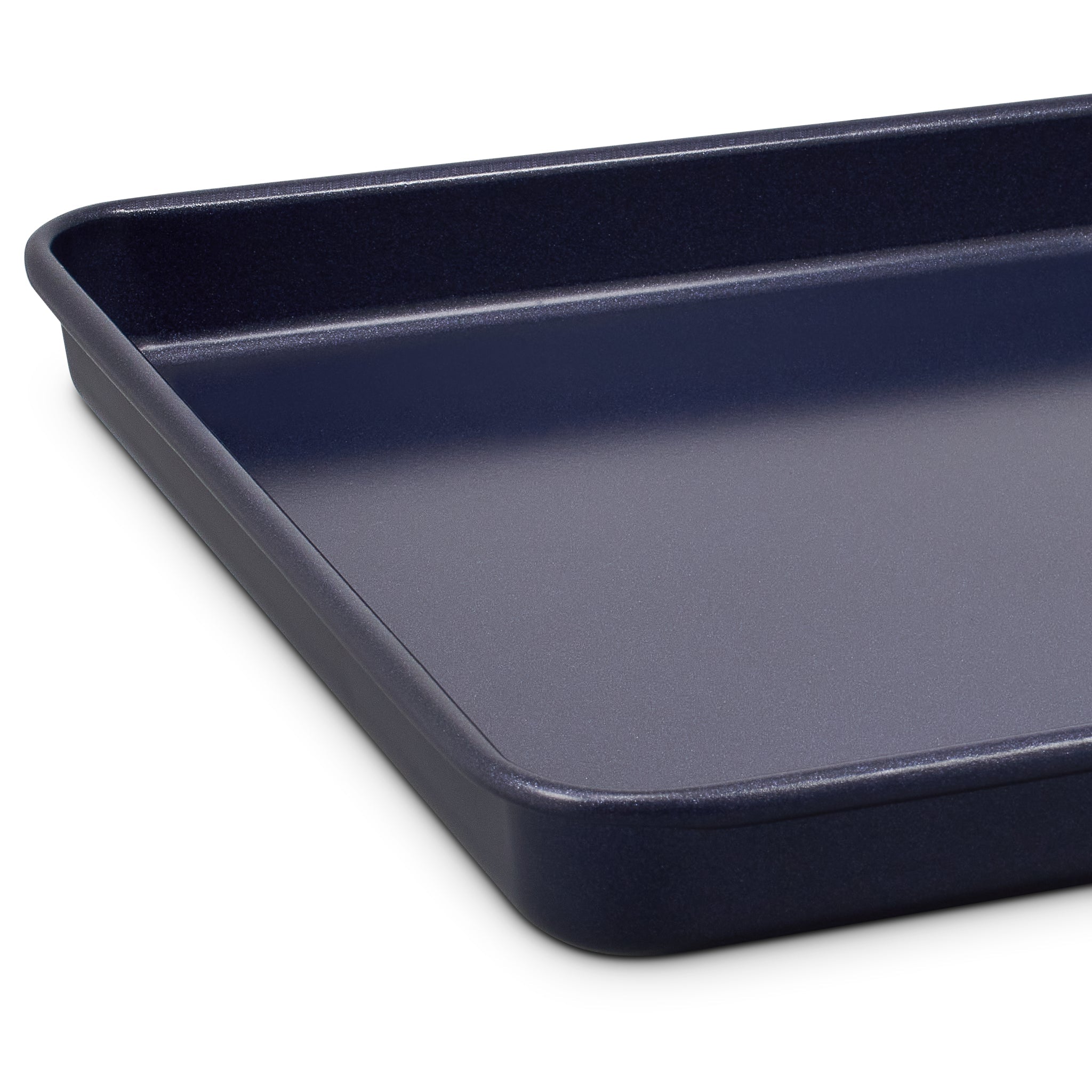 A close-up of a dark blue rectangular baking sheet with raised edges, shown on a white background.
