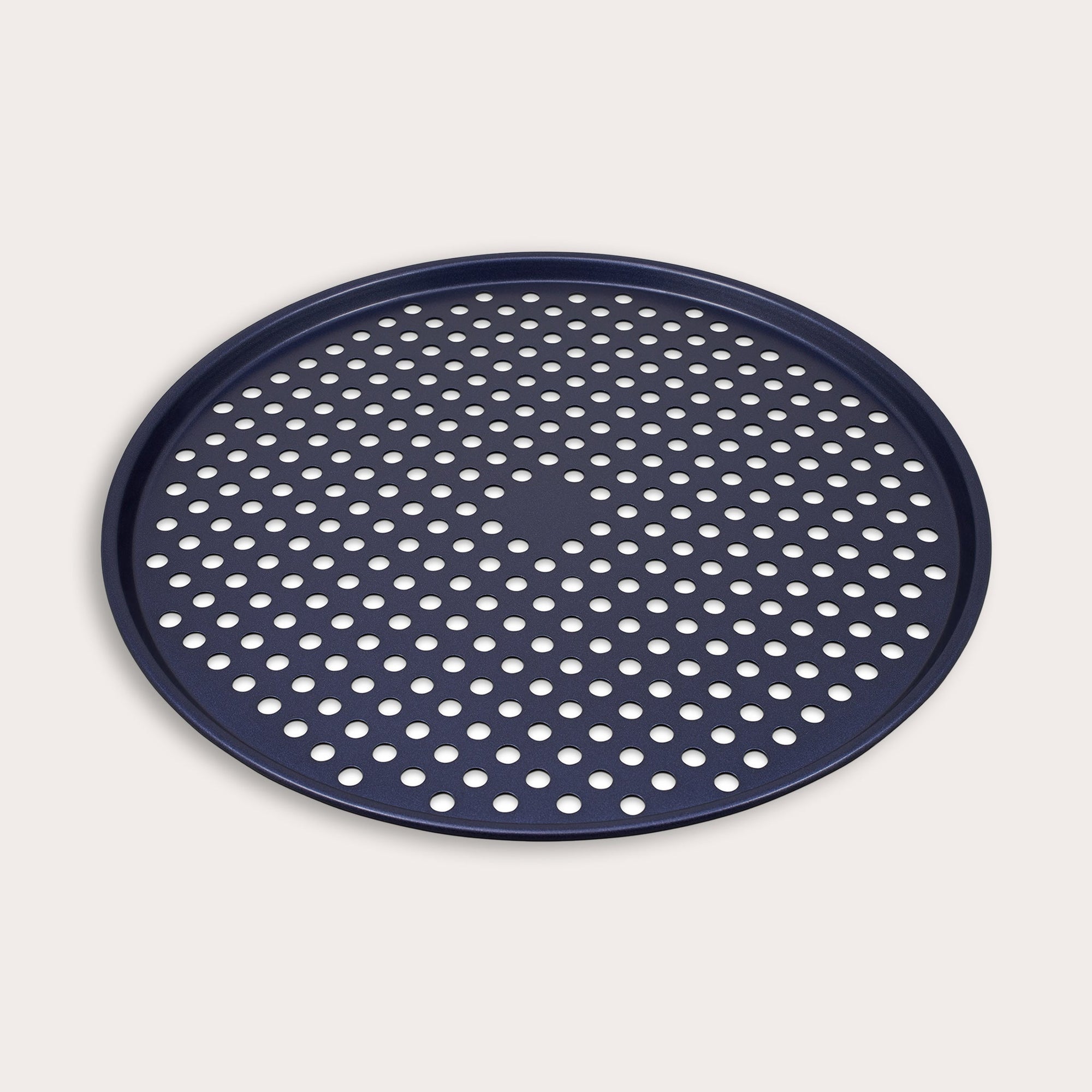 A round, dark blue pizza pan with a raised edge and evenly spaced perforated holes across the bottom, displayed on a plain, light background.