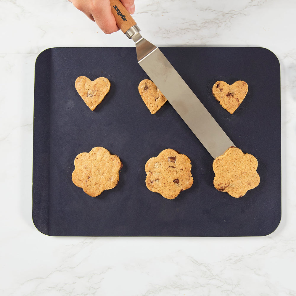 The Zyliss Durable Non-Stick Baking Sheet, a dark gray rectangular pan with rounded corners and heavy-gauge carbon steel construction, is displayed on a plain, light background.
