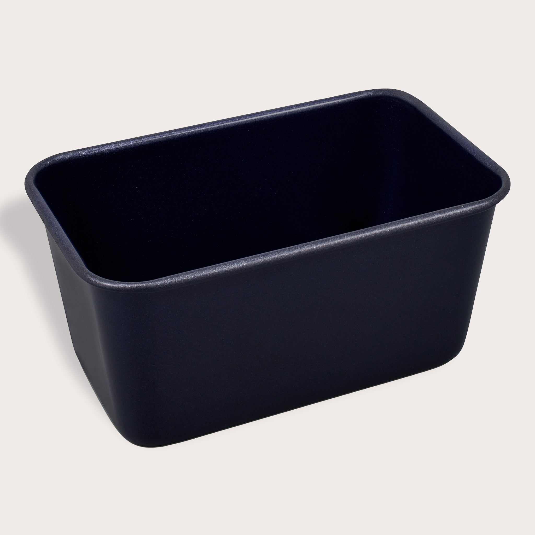 A black rectangular loaf pan with rounded corners, viewed from a slight angle against a plain light background.
