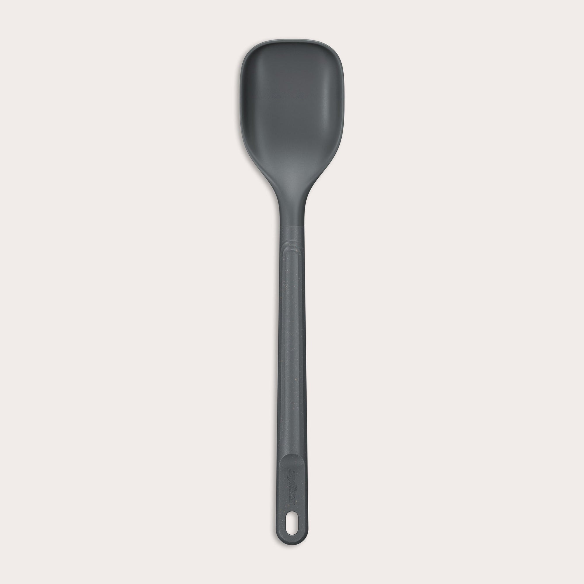 The Zyliss Spoon is a dark gray, heat-resistant silicone utensil with a long handle and end hole, ideal for cooking or serving. Shown against a plain light background. #Medium