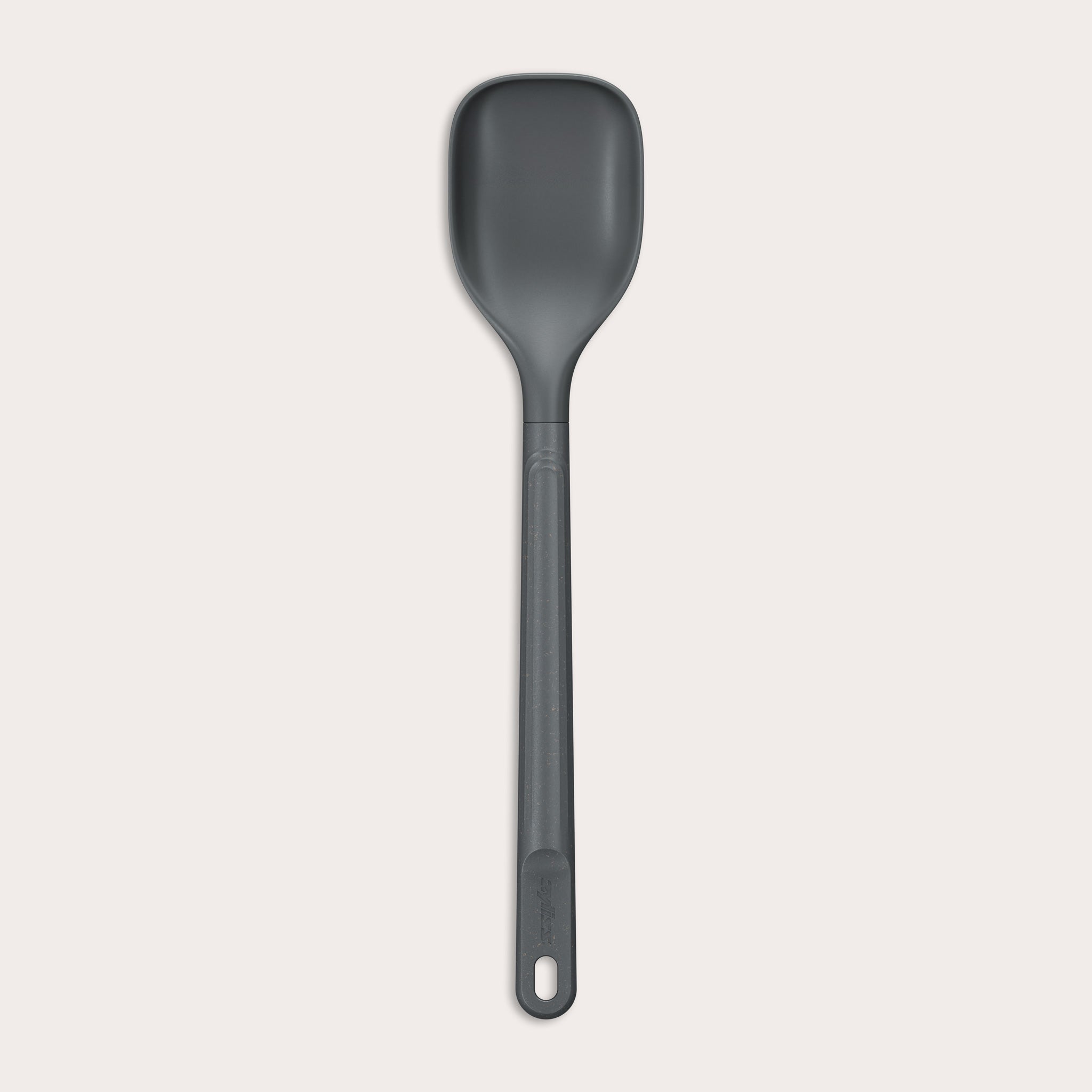 The Zyliss Spoon is a dark gray, heat-resistant silicone utensil with a long handle and end hole, ideal for cooking or serving. Shown against a plain light background. #Medium