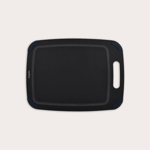 The Zyliss Wood Fibre Cutting Board is a rectangular, black, eco-friendly board with rounded corners, groove edging, right-side handle cutout, and dark blue corner accents. Made from recycled wood fibres. Shown on a plain white background. #Medium