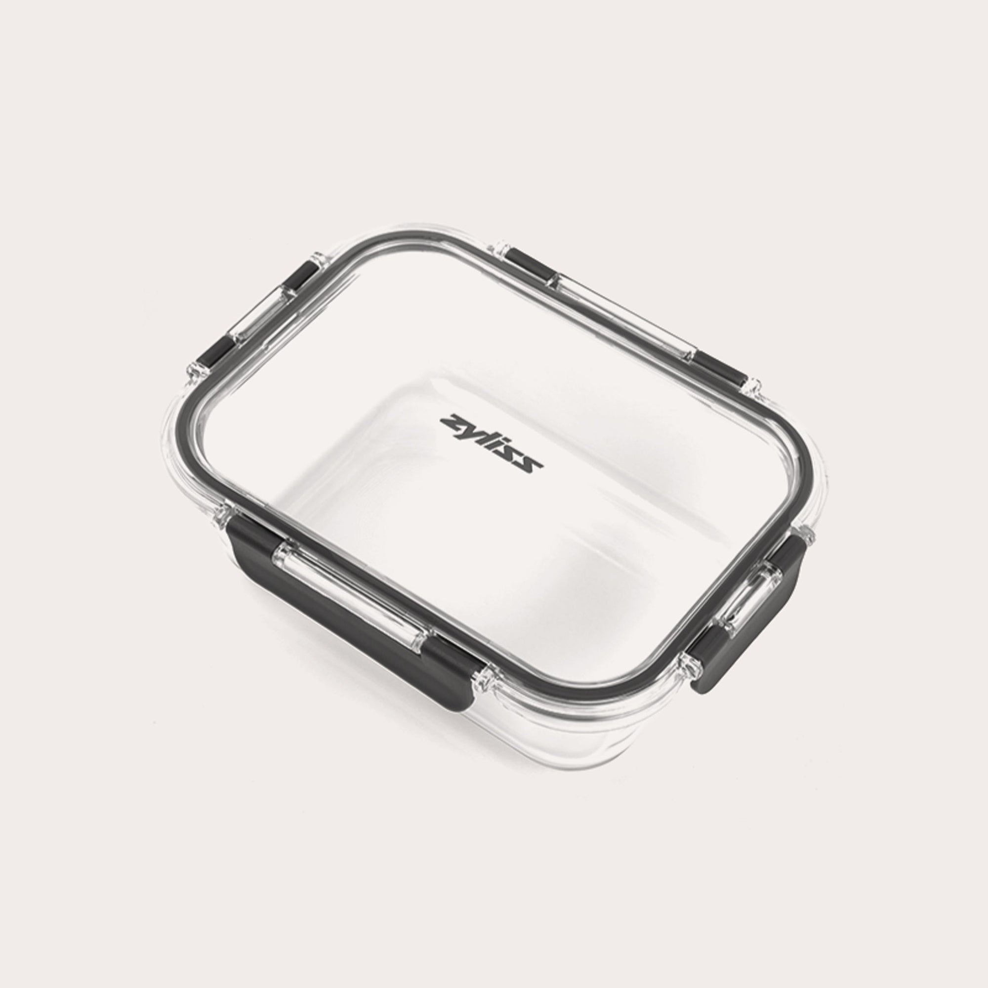 A rectangular clear Zyliss Glass Container for meal prep features a transparent lid with four black locking clips, Zyliss printed in black on the lid, all shown against a plain light background. #1.05L/1.1qt