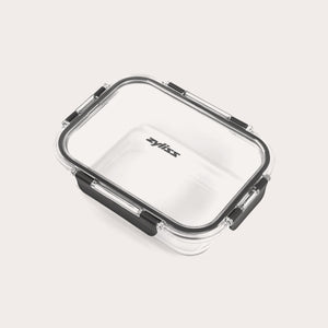 A rectangular clear Zyliss Glass Container for meal prep features a transparent lid with four black locking clips, Zyliss printed in black on the lid, all shown against a plain light background. #1.05L/1.1qt