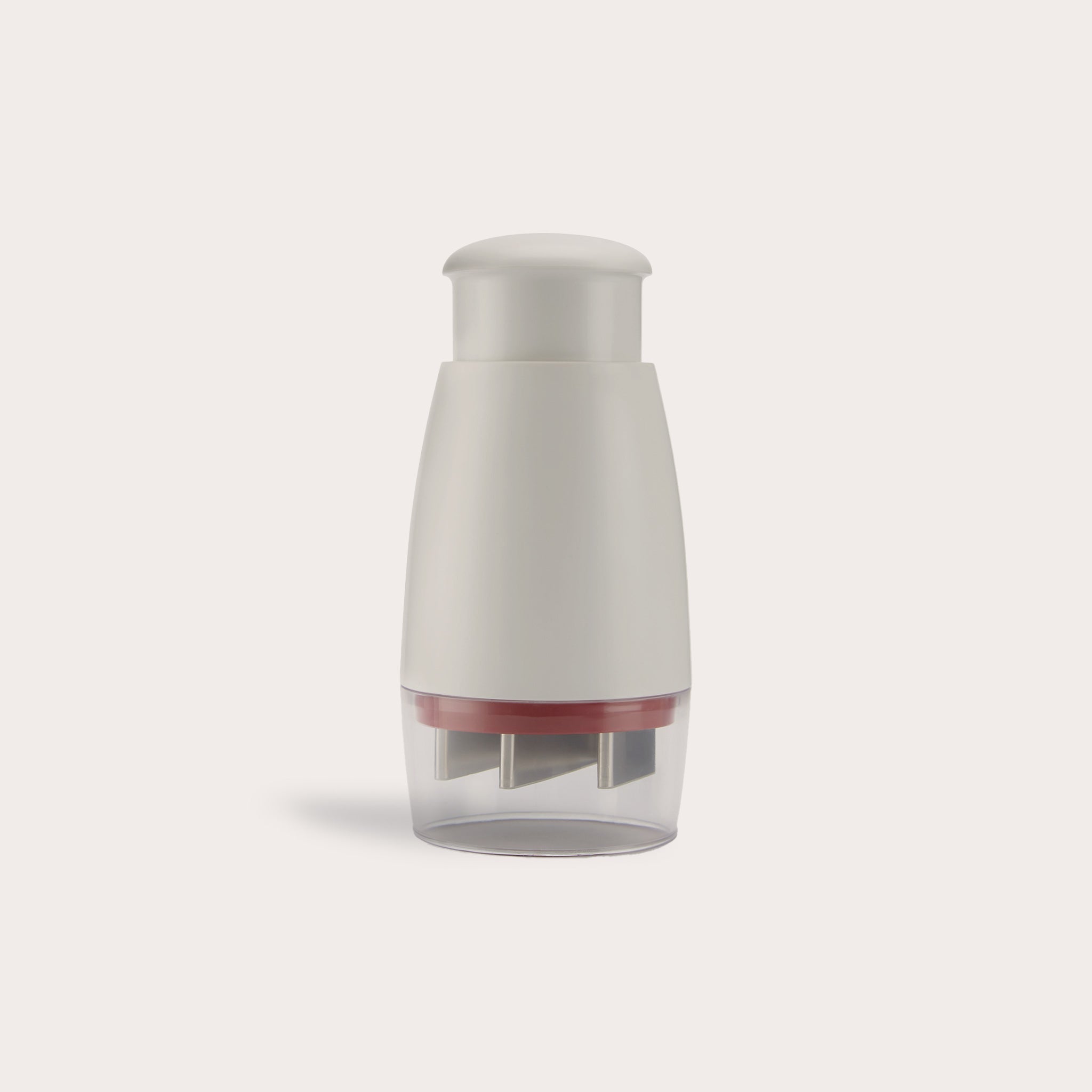 The Zyliss Zick-Zick Classic Food Chopper has a white and gray handheld design, rounded top, transparent base with metal blades, and is ideal for efficient kitchen storage. Shown against a plain light background. 